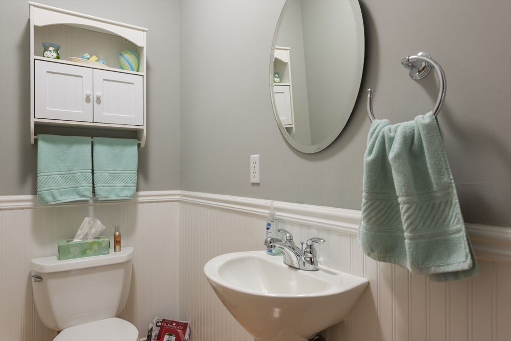 9 Hathaway Pond Circle, Unit 9 Rochester, MA 02770 - Photo 20 of 38 a bathroom with a toilet sink and mirror
