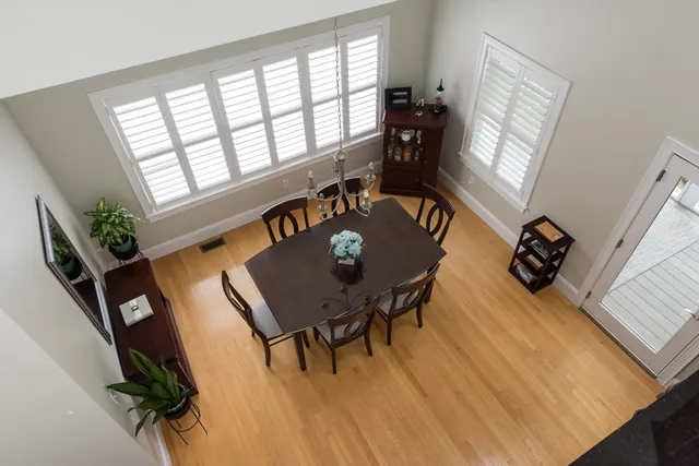 a view of a livingroom with furniture hardwood floor and workspace