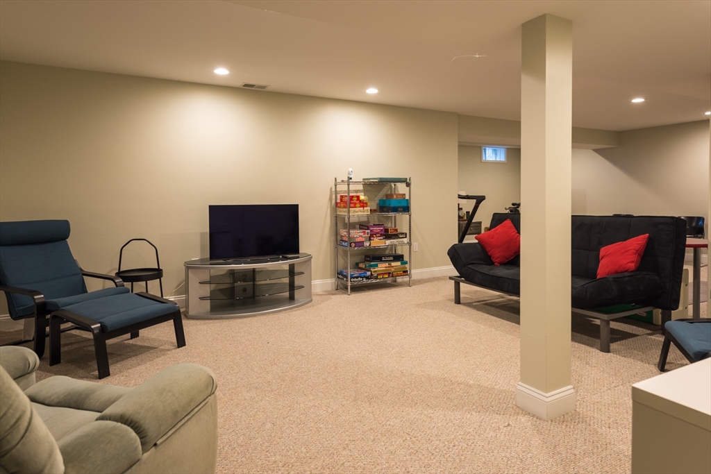 9 Hathaway Pond Circle, Unit 9 Rochester, MA 02770 - Photo 26 of 38 a living room with furniture and a flat screen tv