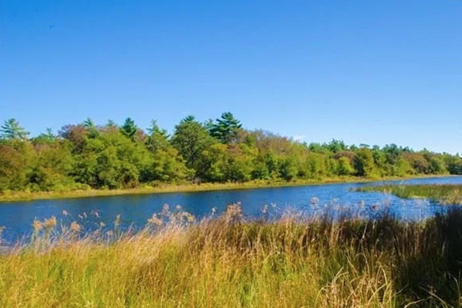 9 Hathaway Pond Circle, Unit 9 Rochester, MA 02770 - Photo 34 of 38 a view of a lake with a city