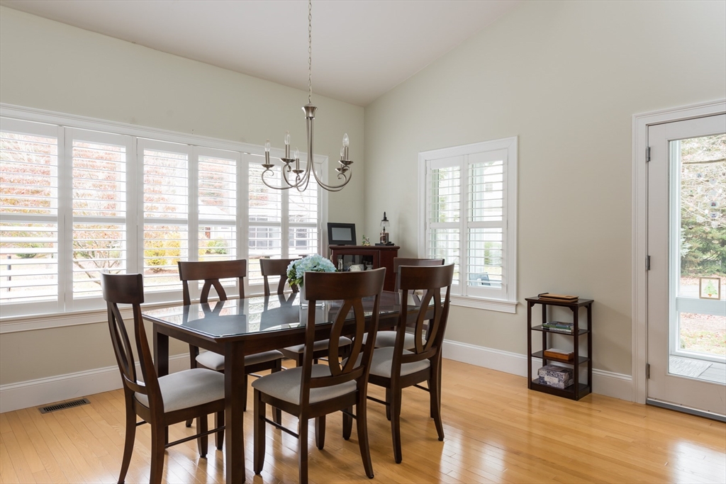 9 Hathaway Pond Circle, Unit 9 Rochester, MA 02770 - Photo 8 of 38 a view of a dining room with furniture window and wooden floor
