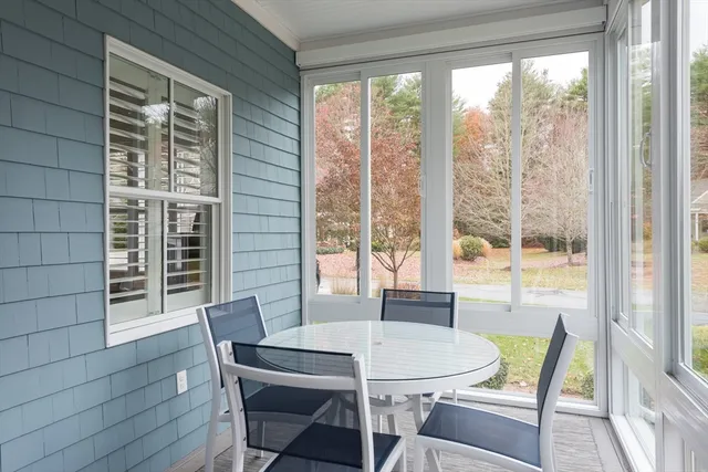 a dining room with furniture window and outside view
