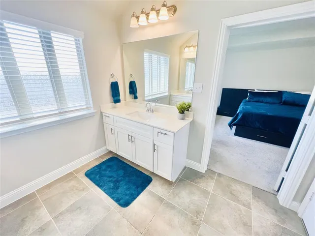 a bathroom with a sink a vanity and a mirror