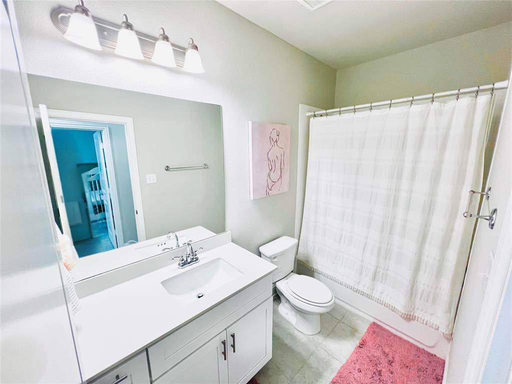 552 Sequoia Street Allen, TX 75002 - Photo 15 of 20 a bathroom with a toilet a sink and a mirror