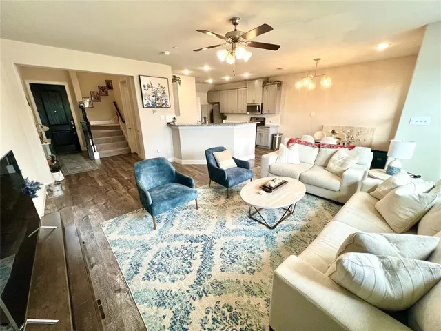 a living room with furniture and kitchen view