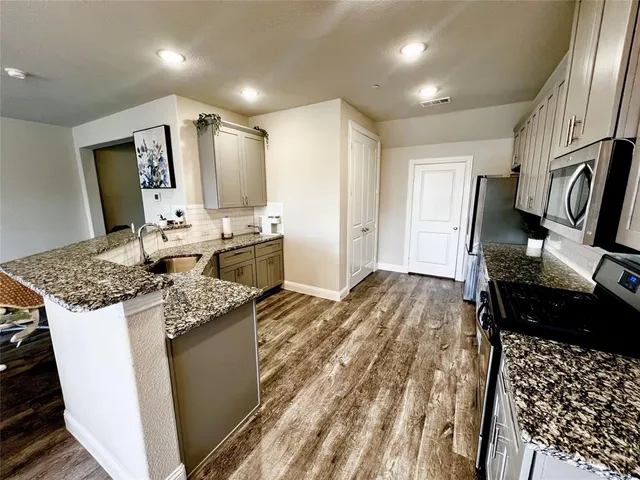 a kitchen with a stove and a refrigerator