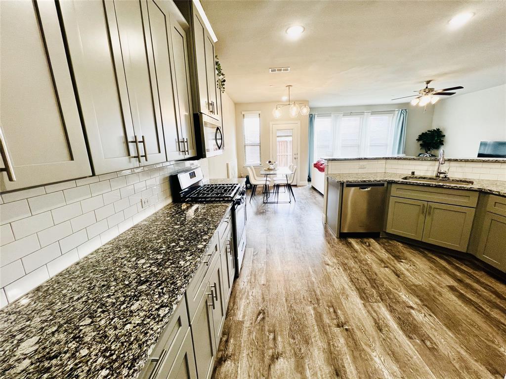 552 Sequoia Street Allen, TX 75002 - Photo 5 of 20 a large kitchen with a sink and cabinets
