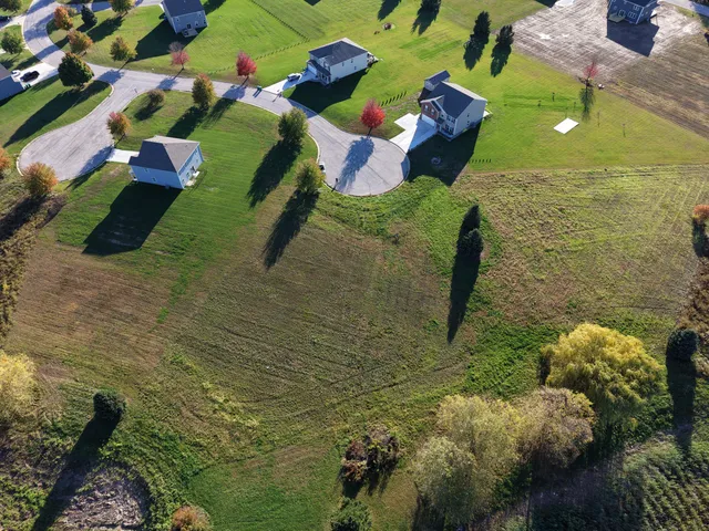 an aerial view of a house with a yard basket ball court