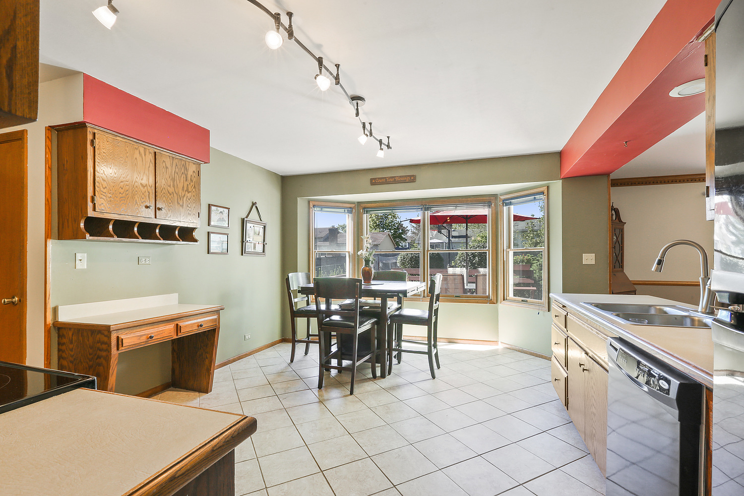 3582 Ronald Road Crete, IL 60417 - Photo 5 of 16 a room with stainless steel appliances kitchen island granite countertop a table chairs and a refrigerator