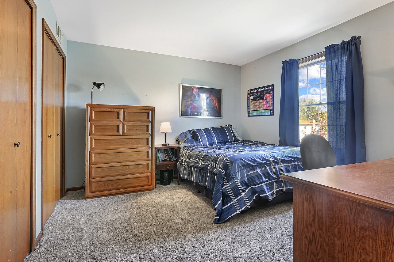 3582 Ronald Road Crete, IL 60417 - Photo 10 of 16 a bedroom with a bed and a dresser