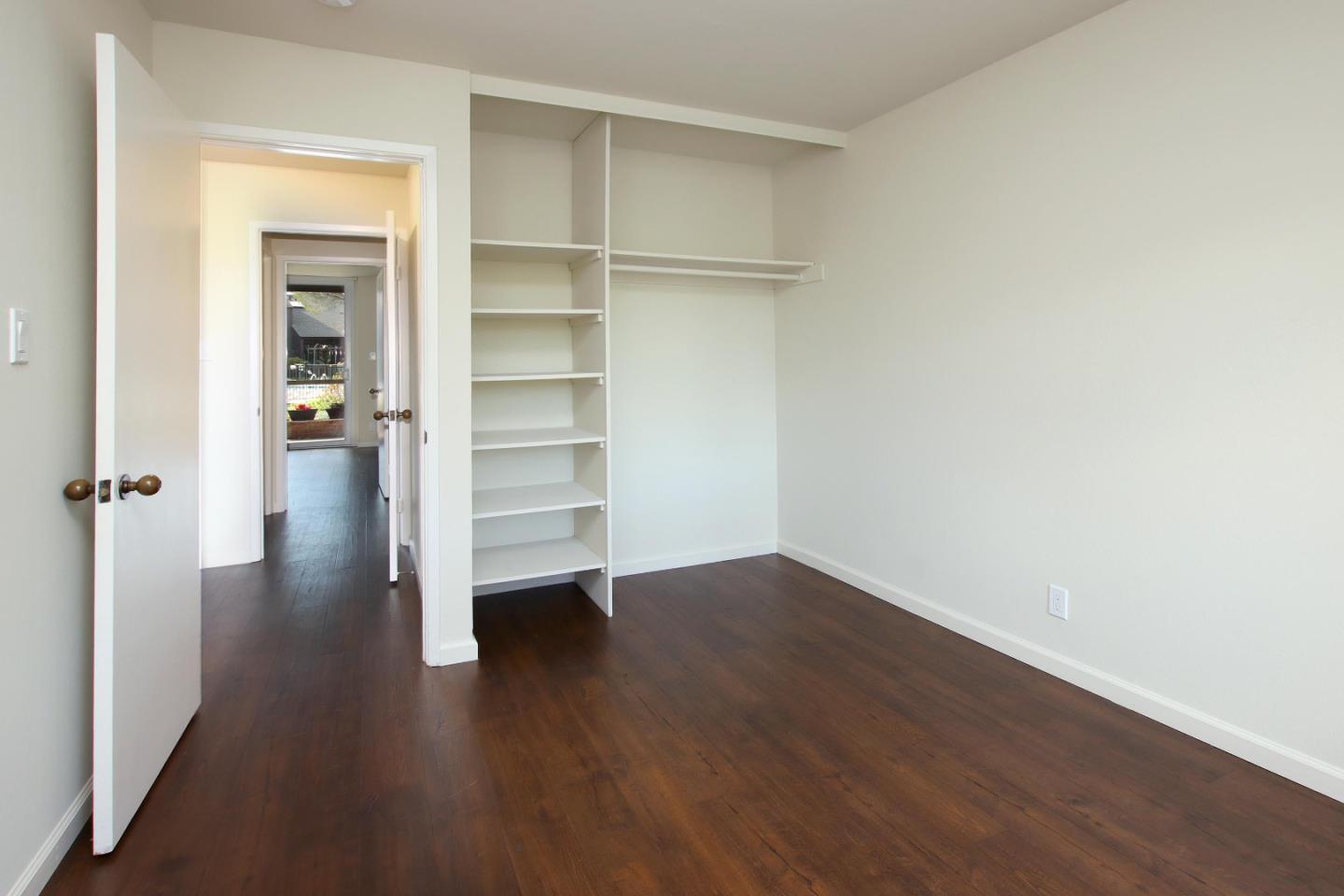 103 Shelter Lagoon Drive Santa Cruz, CA 95060 - Photo 14 of 39 an empty room with wooden floor closet and windows