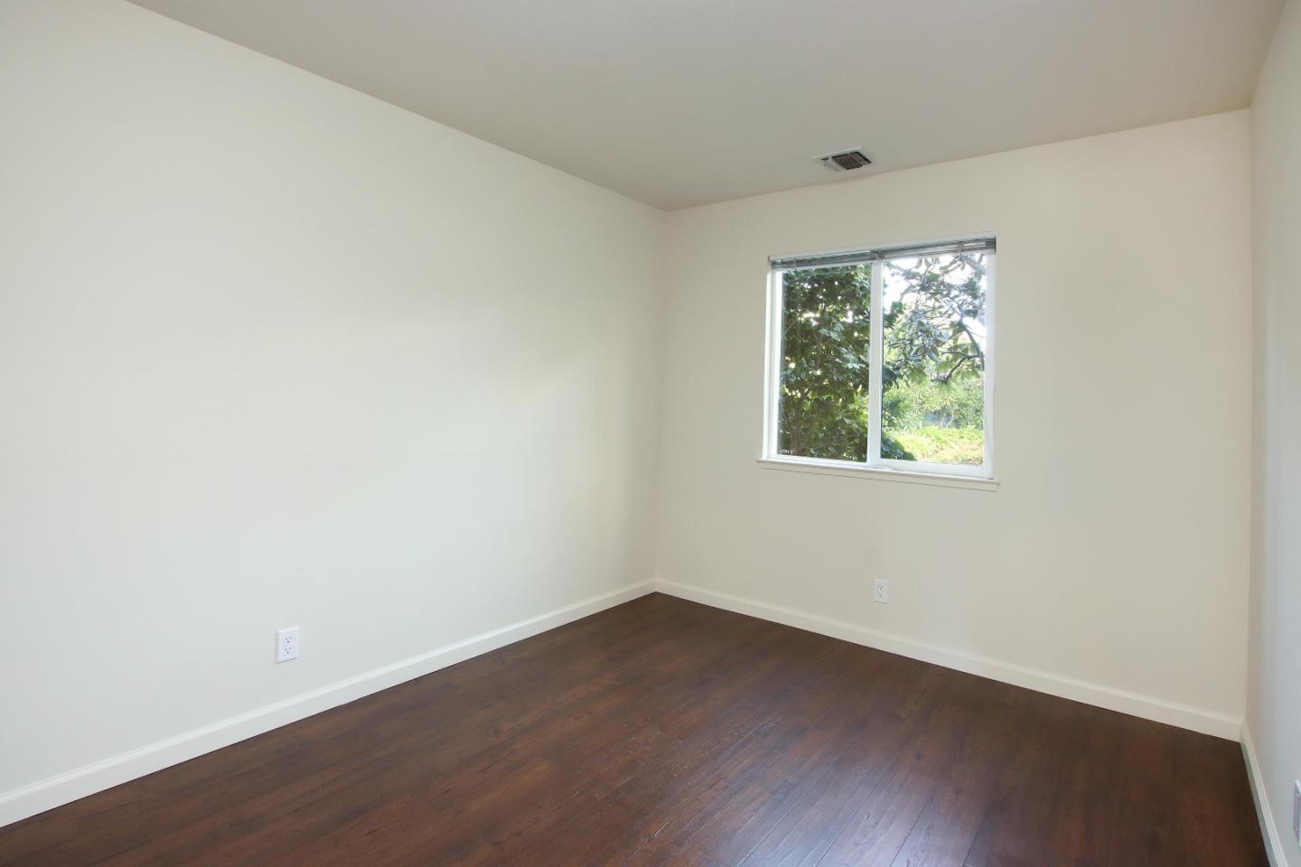 103 Shelter Lagoon Drive Santa Cruz, CA 95060 - Photo 15 of 39 an empty room with wooden floor and windows