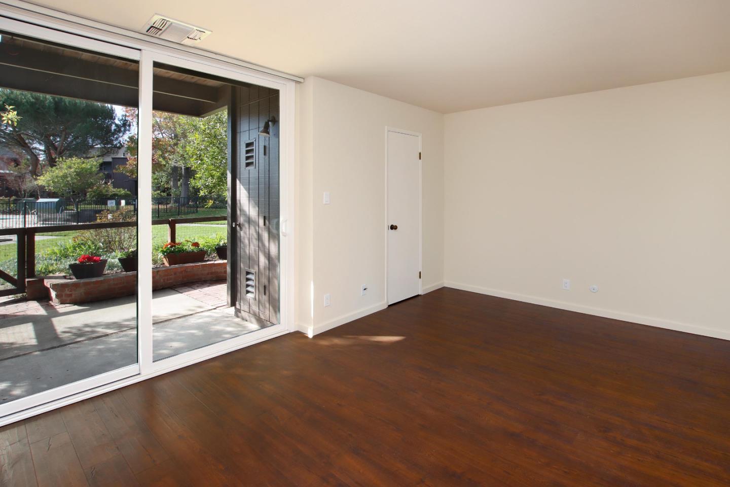 103 Shelter Lagoon Drive Santa Cruz, CA 95060 - Photo 19 of 39 an empty room with wooden floor and windows