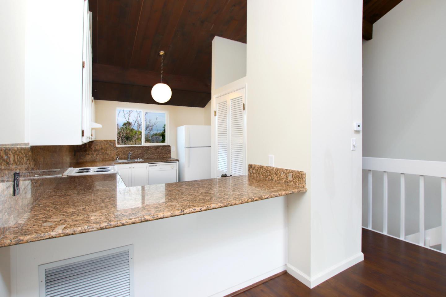 103 Shelter Lagoon Drive Santa Cruz, CA 95060 - Photo 6 of 39 a kitchen with granite countertop a sink and a white wooden cabinets