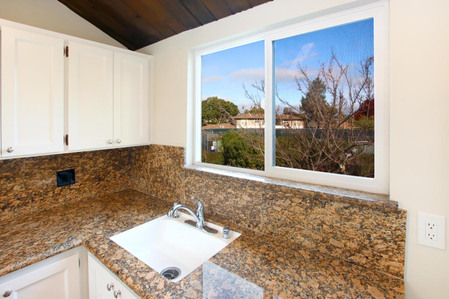 103 Shelter Lagoon Drive Santa Cruz, CA 95060 - Photo 8 of 39 a bathroom with a granite countertop sink and a large mirror