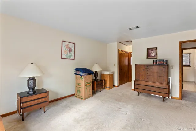 a view of a livingroom with furniture and a lamp