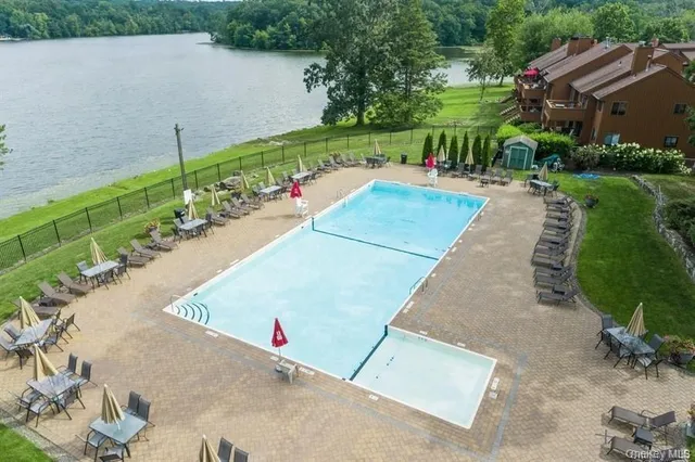 an aerial view of a house with a yard and lake view