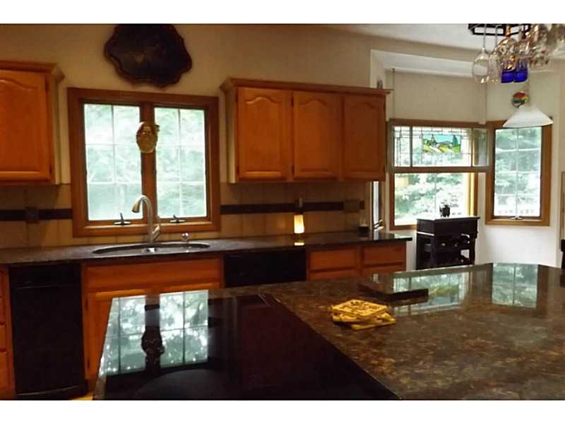 1140 High Hawk Road East Greenwich, RI 02818 - Photo 11 of 18 Kitchen. expansive granite island with new cook top/down draft exhaust fan.