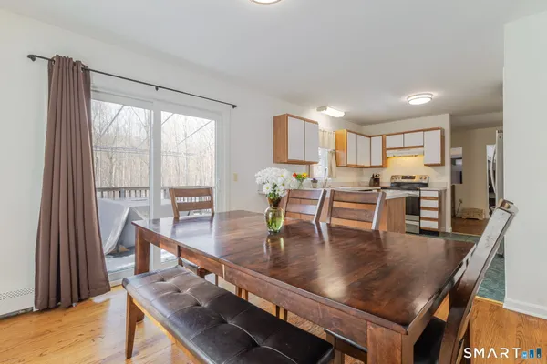 a view of a dining room with furniture and wooden floor