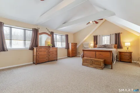 a spacious bedroom with a bed and a window