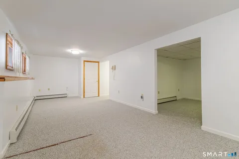 an empty room with windows and closet