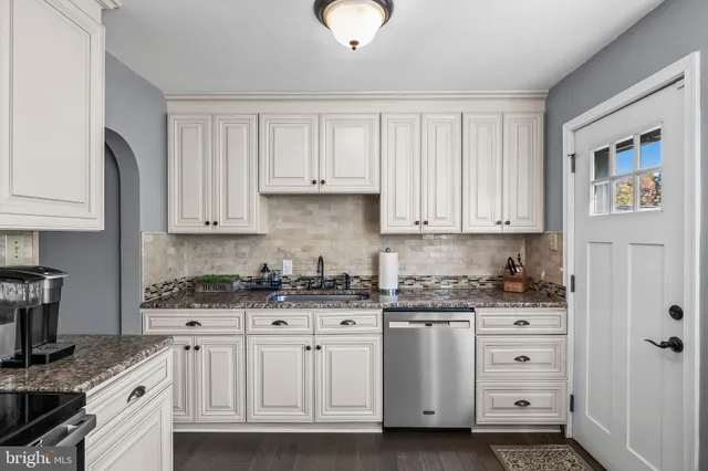 a kitchen with stainless steel appliances granite countertop a sink and cabinets