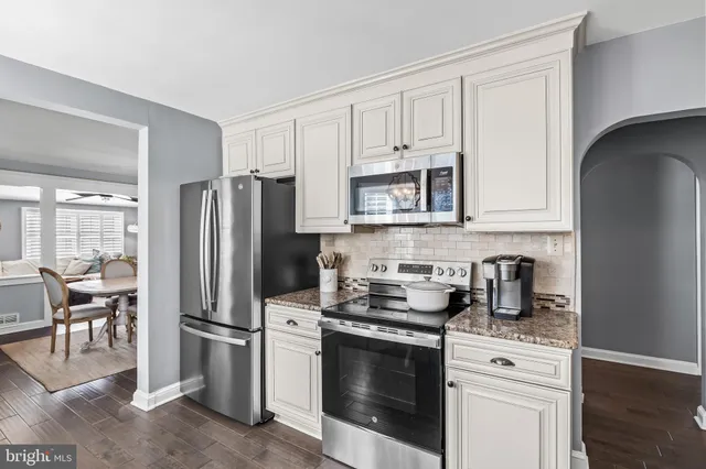 a kitchen with stainless steel appliances a refrigerator stove and microwave