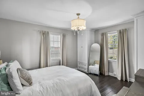 a bedroom with bed and a chandelier