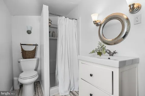 a bathroom with a toilet sink and mirror