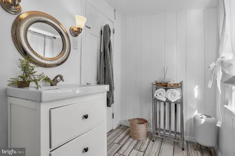 a bathroom with a sink mirror and toilet