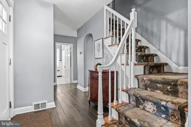 a view of entryway and hall with wooden floor