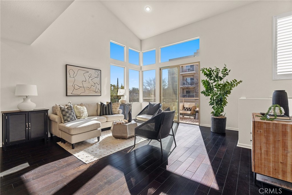 a living room with furniture potted plant and a window