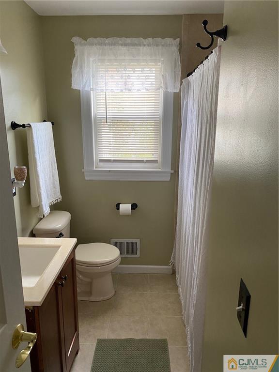 200 New Dover Road Colonia, NJ 07067 - Photo 11 of 14 a bathroom with a sink toilet and mirror