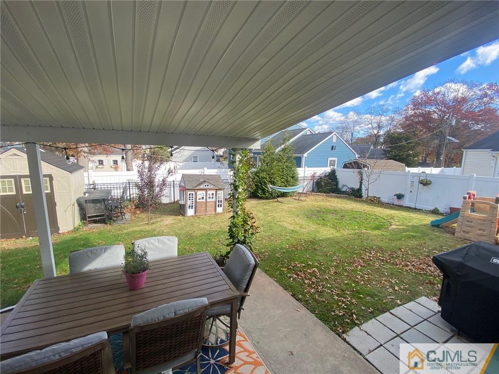 200 New Dover Road Colonia, NJ 07067 - Photo 12 of 14 a view of a patio with table and chairs with wooden floor and fence