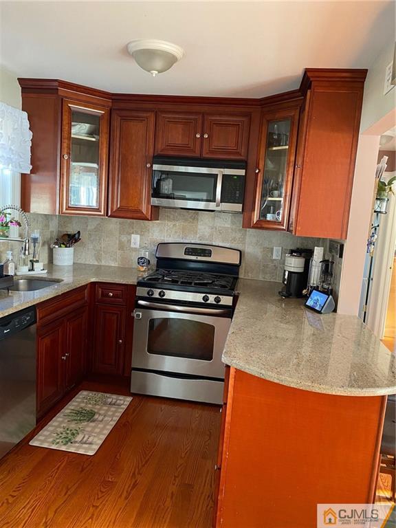 200 New Dover Road Colonia, NJ 07067 - Photo 3 of 14 a kitchen with stainless steel appliances granite countertop a stove a sink and a microwave
