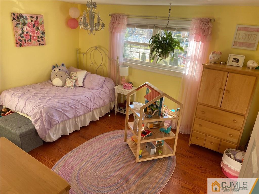 200 New Dover Road Colonia, NJ 07067 - Photo 7 of 14 a bedroom with a bed and a mirror on the dresser