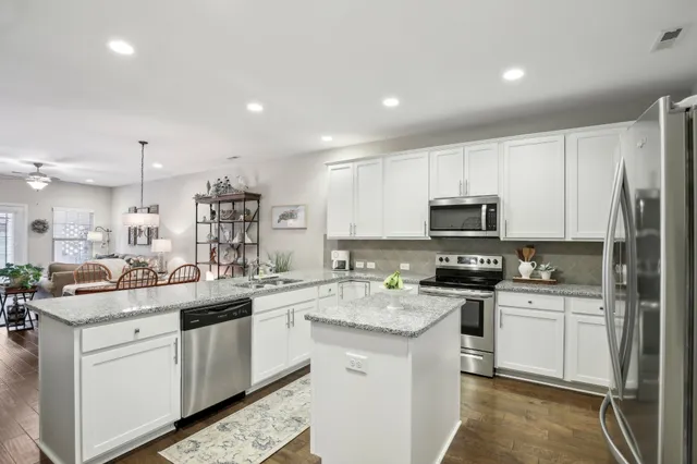 a kitchen with cabinets and stainless steel appliances