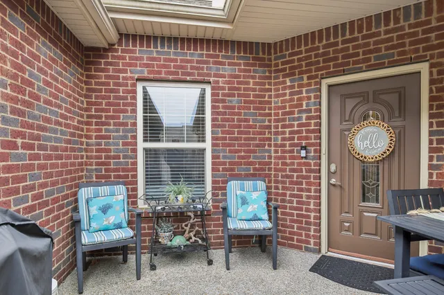 a brick building with a bench and a table