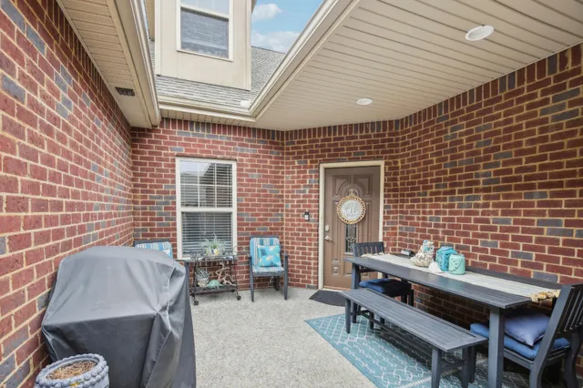 a backyard of a house with outdoor seating