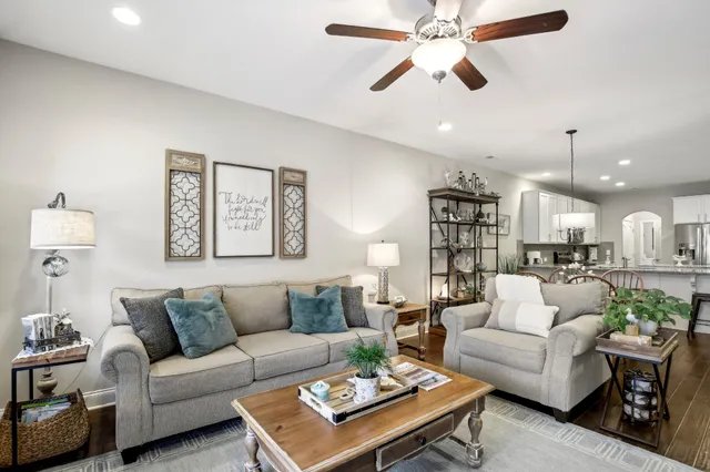 a living room with furniture a rug and a chandelier