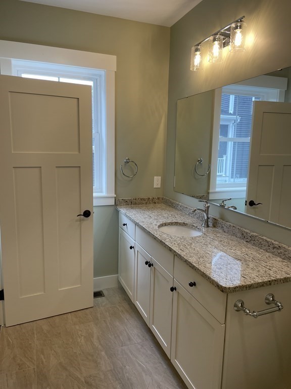 3 Powell Street, Unit B Devens, MA 01434 - Photo 13 of 28 a bathroom with a granite countertop sink and a mirror