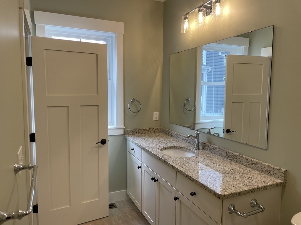 3 Powell Street, Unit B Devens, MA 01434 - Photo 14 of 28 a bathroom with a granite countertop sink and a mirror