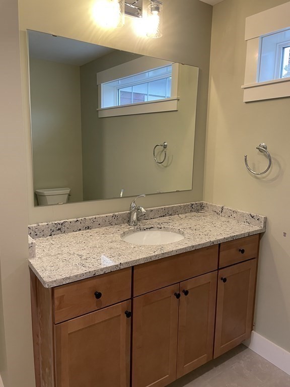 3 Powell Street, Unit B Devens, MA 01434 - Photo 19 of 28 a bathroom with a granite countertop sink and a mirror