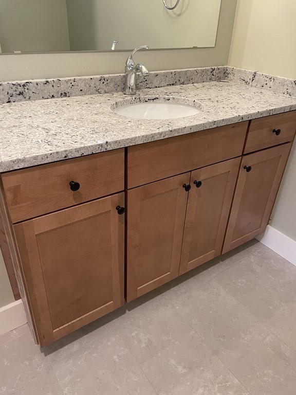 3 Powell Street, Unit B Devens, MA 01434 - Photo 20 of 28 a bathroom with a granite countertop sink and a mirror