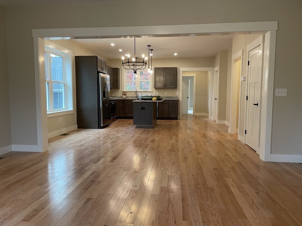 3 Powell Street, Unit B Devens, MA 01434 - Photo 5 of 28 a large kitchen with a wooden floor and stainless steel appliances
