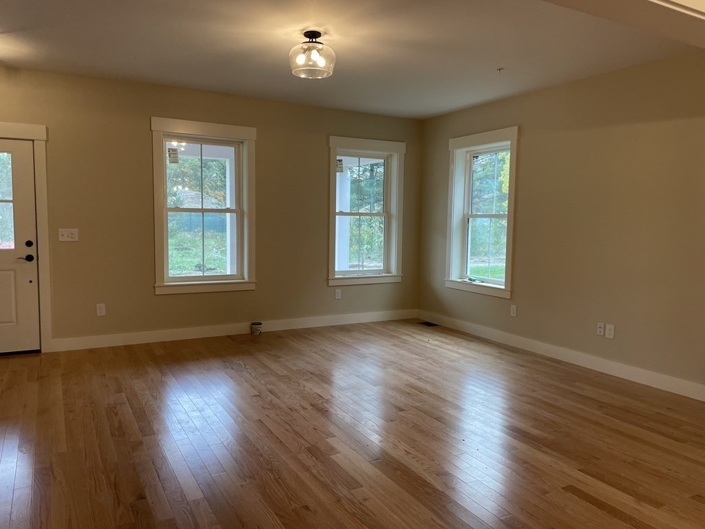 3 Powell Street, Unit B Devens, MA 01434 - Photo 8 of 28 a view of an empty room with wooden floor and a window