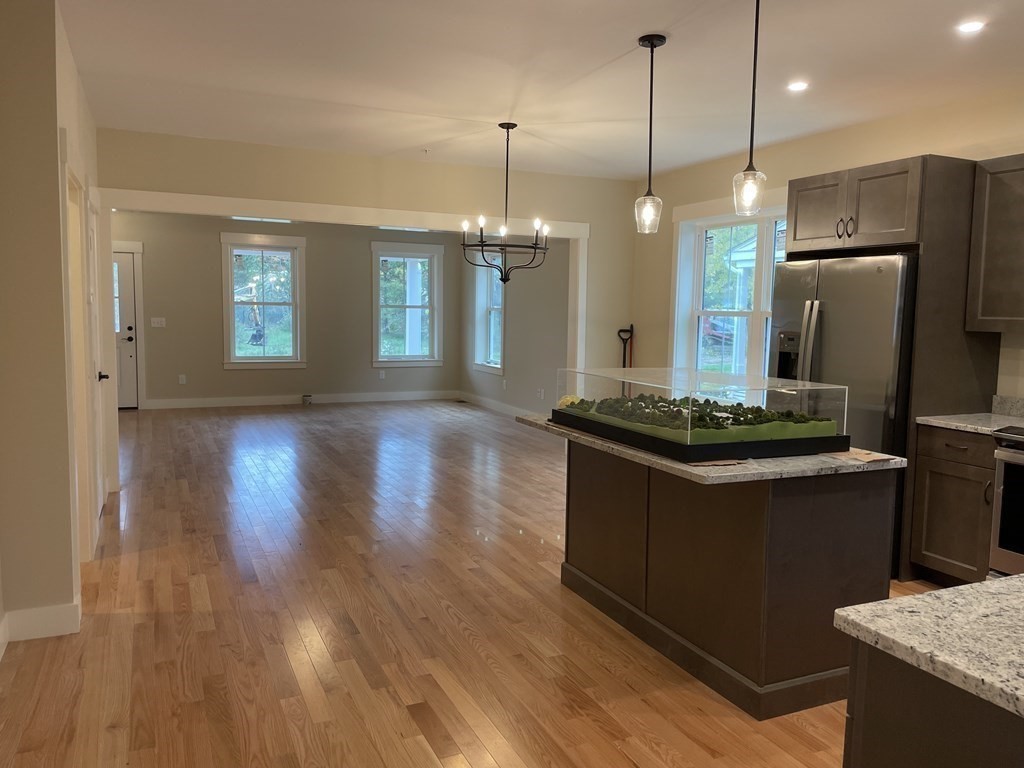 3 Powell Street, Unit B Devens, MA 01434 - Photo 9 of 28 a kitchen with refrigerator and wooden floor
