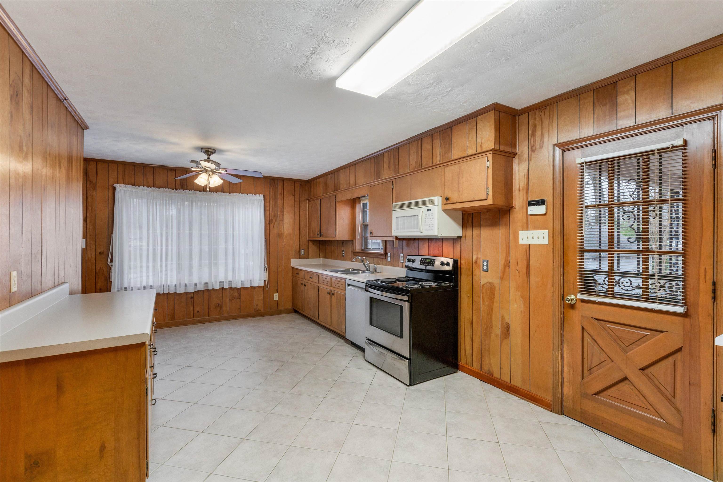 1217 Vaughn Road Memphis, TN 38122 - Photo 11 of 27 a kitchen with stainless steel appliances granite countertop a refrigerator and a stove top oven with wooden floor