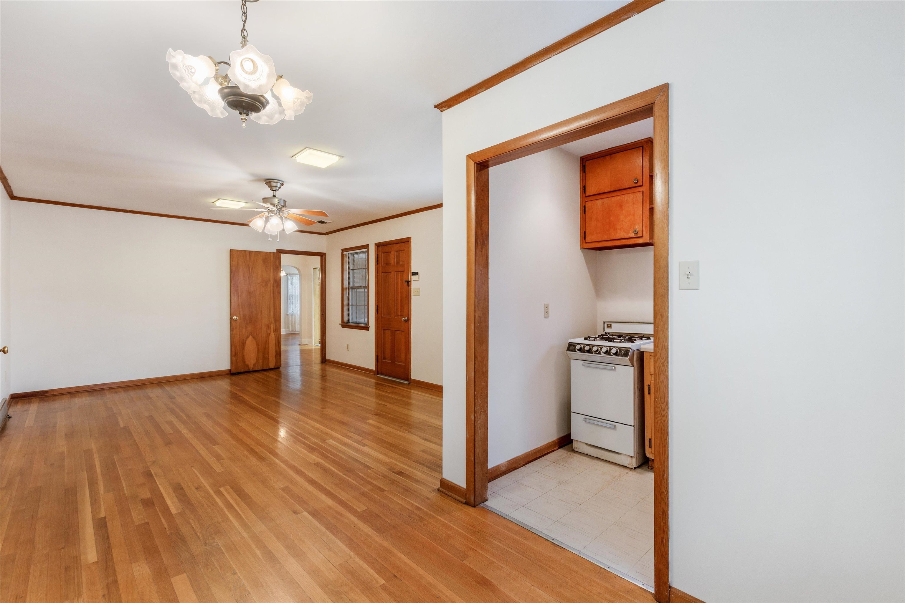 1217 Vaughn Road Memphis, TN 38122 - Photo 14 of 27 a view of a hallway with wooden floor and a kitchen