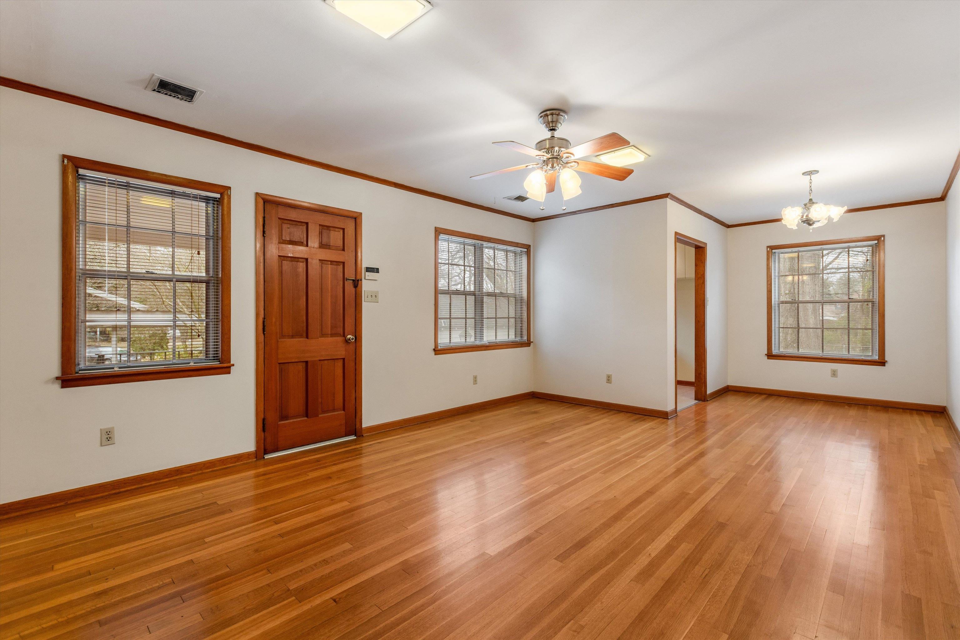1217 Vaughn Road Memphis, TN 38122 - Photo 18 of 27 a view of an empty room with window and wooden floor